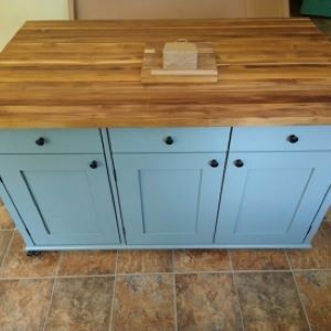 blue kitchen island with wood top and cutting board