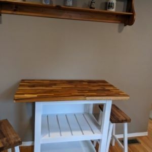 white kitchen island with wood top and stools