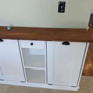 White cabinet with shelf in the middle and wood top