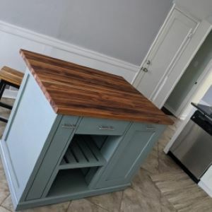 bluish green kitchen island with wood top