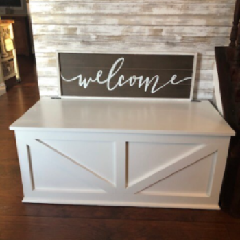 white storage bench with "Welcome" sign