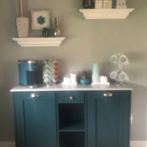 blue cabinet with shelf in middle with coffee items