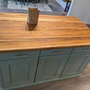 blue kitchen island with wood top and bag and cutting board