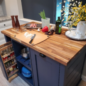 blue kitchen island with wood top with food