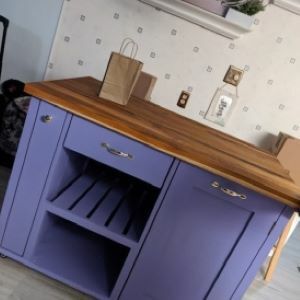 blue kitchen island with wood top with bag