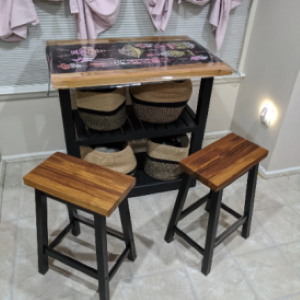 black stools with wood seat in front of table