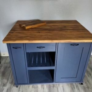 blue kitchen island with wood top with chopping board