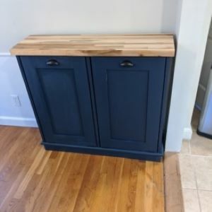 blue trash bin cabinet with wood top