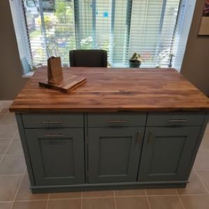 blue-green kitchen island with wood top
