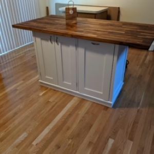 gray kitchen island with wood top and bag on top