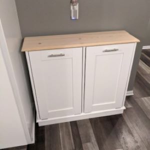white trash bin cabinet with wood top