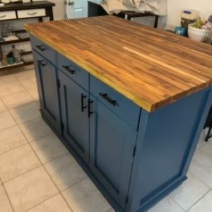 greenish blue kitchen island with wood top